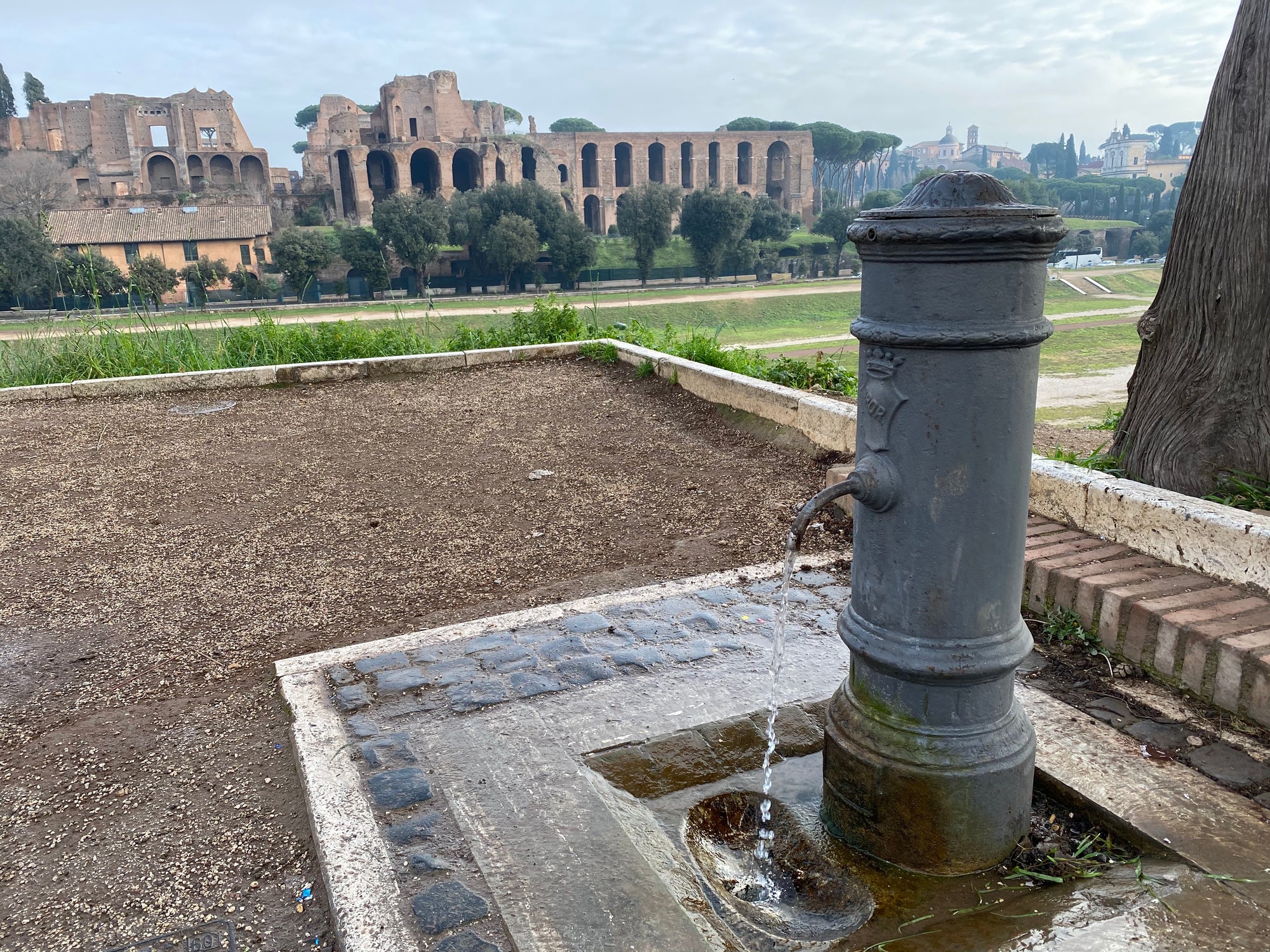 Nasoni drinking fountain in front of Roman Colosseum. 