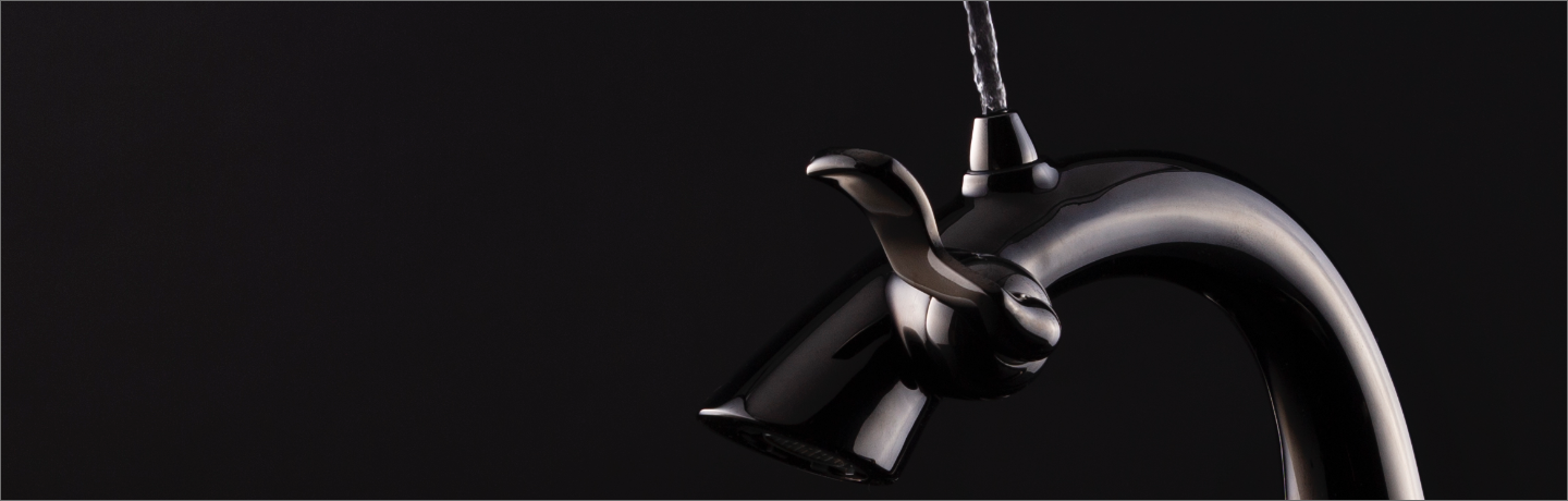 Cropped image of Brushed Nickel Nasoni faucet in use on black background